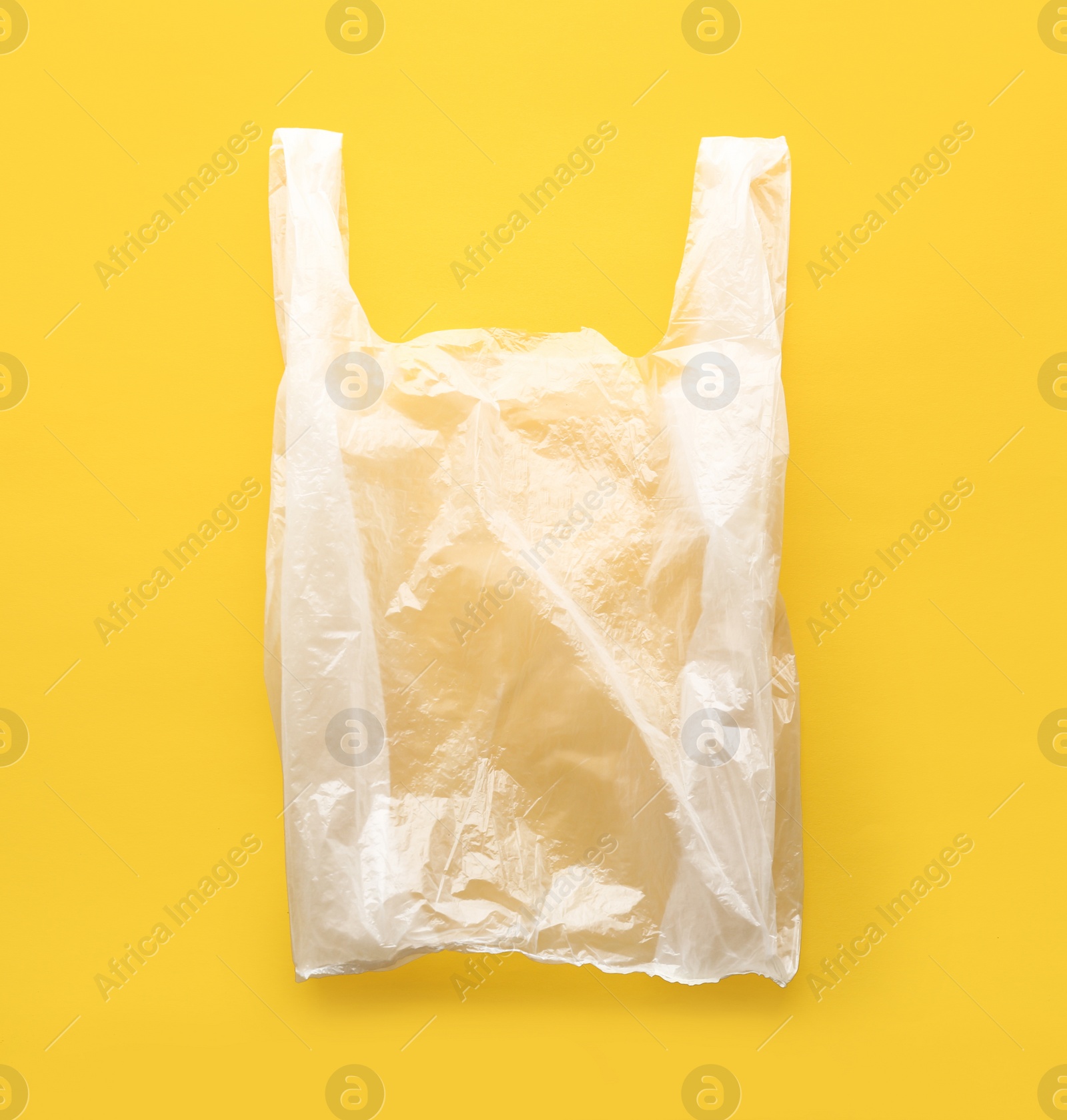 Photo of Clear disposable plastic bag on color background