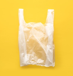 Clear disposable plastic bag on color background