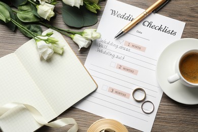 Photo of Flat lay composition with planner and Wedding Checklist on wooden table