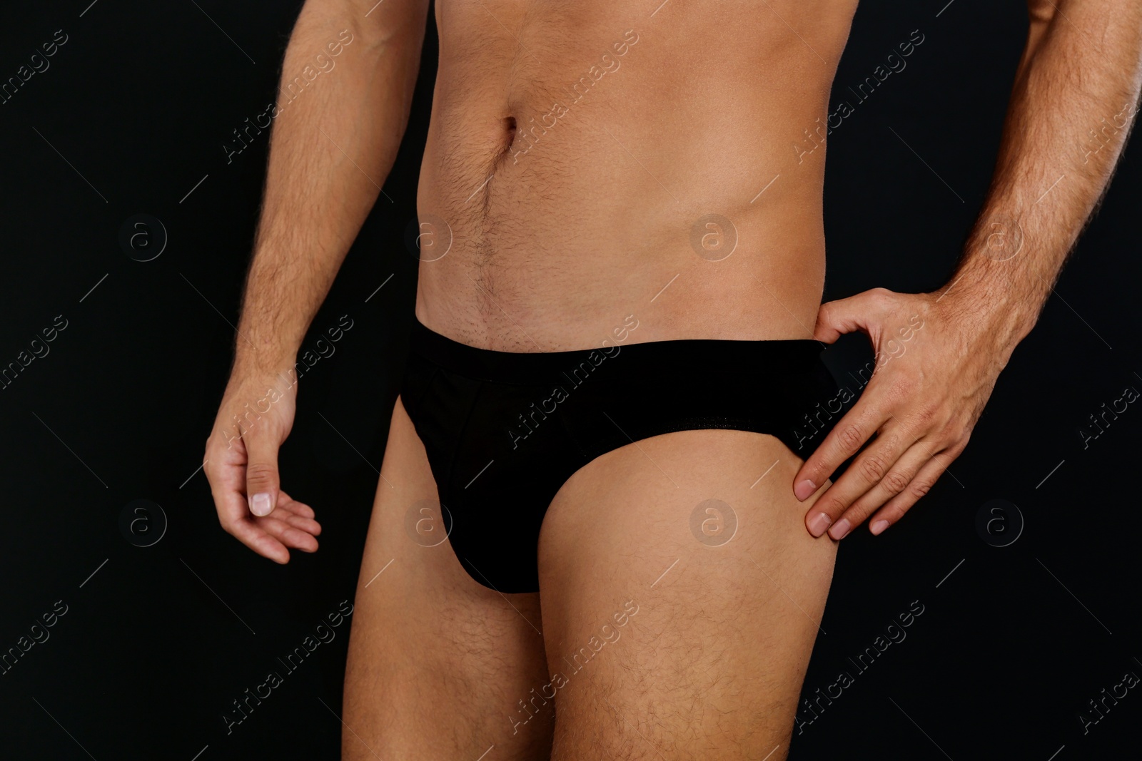 Photo of Man in underwear on black background, closeup