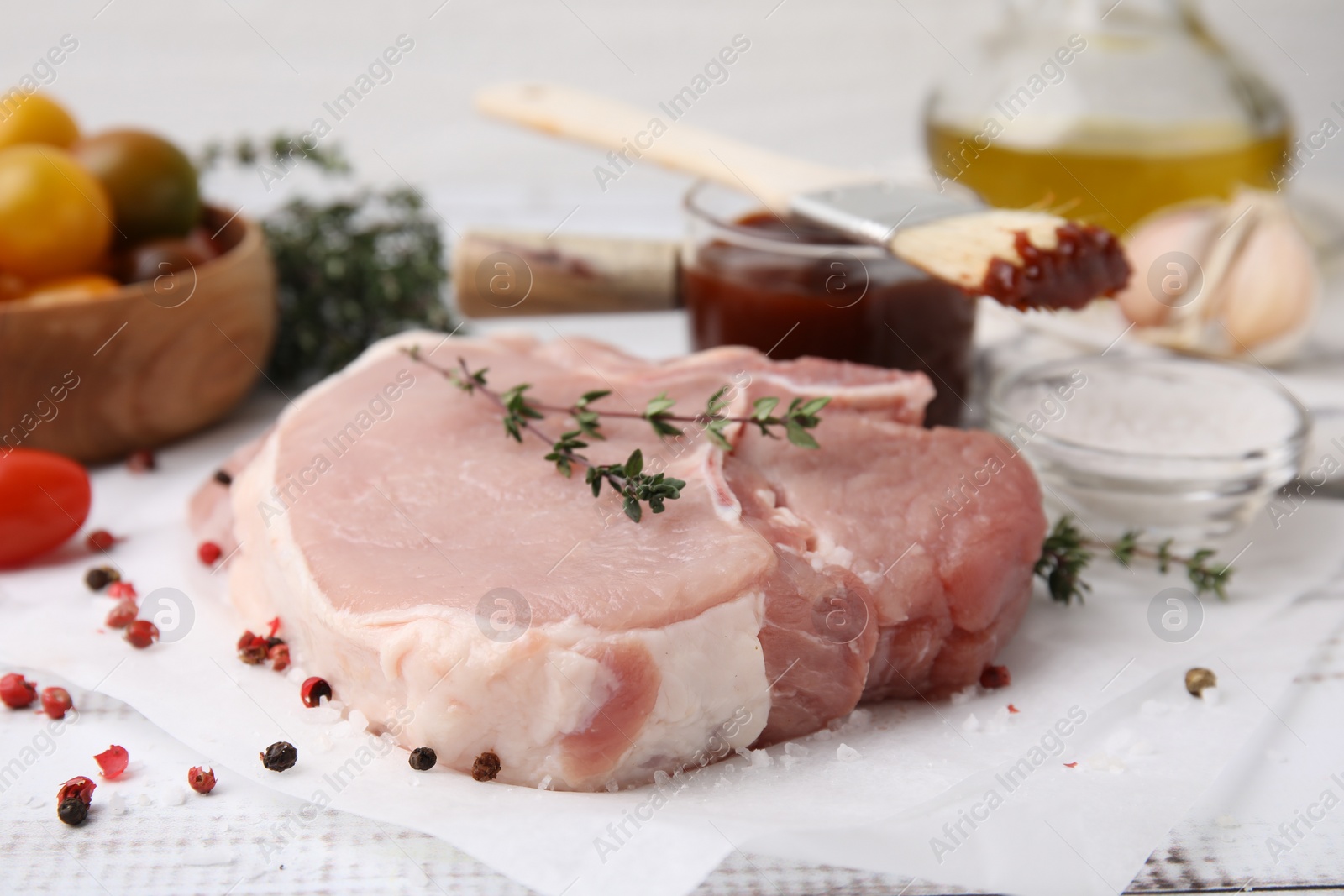 Photo of Raw meat, thyme and spices on table, closeup