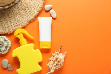 Photo of Suntan products, straw hat and seashells on orange background, flat lay. Space for text