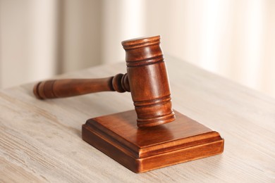 Photo of Law concept. Gavel on wooden table, closeup