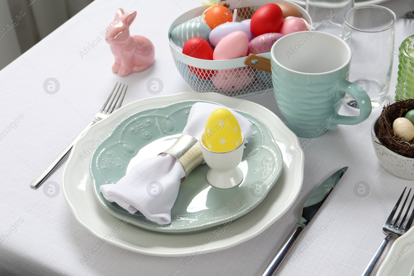 Photo of Easter celebration. Festive table setting with painted eggs.