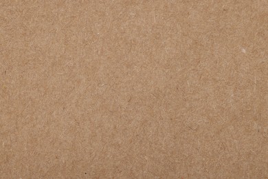 Photo of Texture of brown paper sheet as background, top view