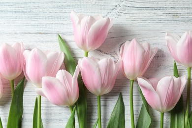 Beautiful composition with tulips for Mother's Day on wooden background