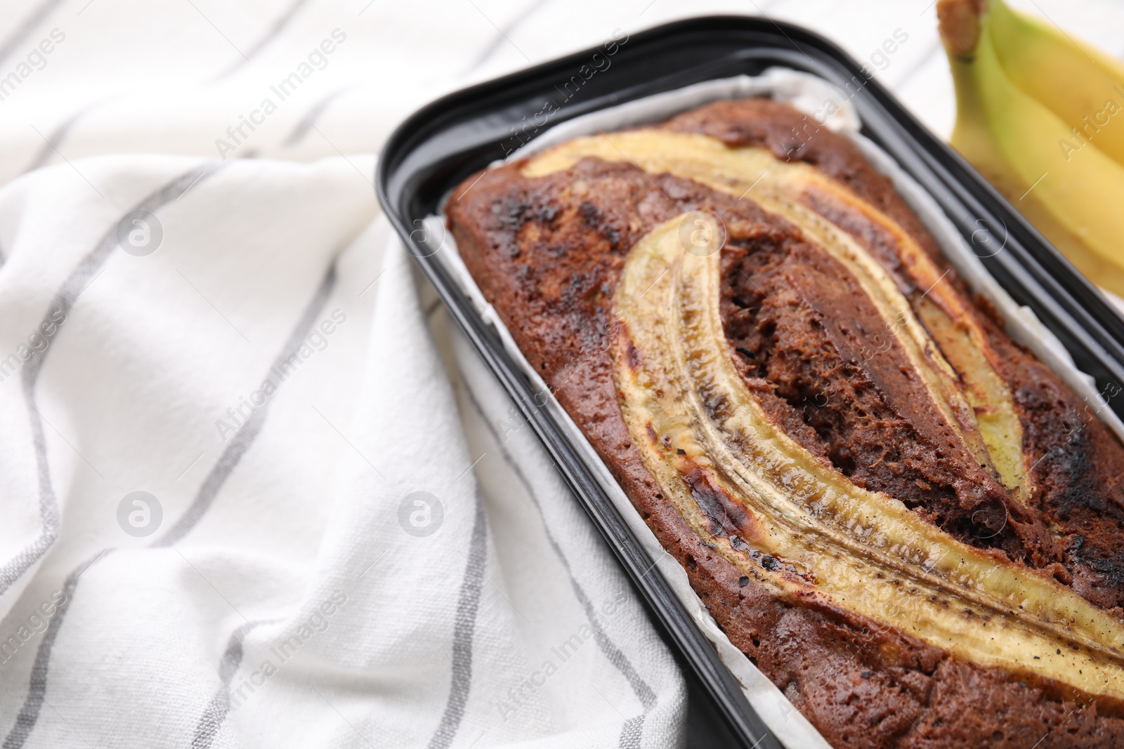 Photo of Delicious homemade banana bread on table, closeup. Space for text