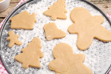 Raw Christmas cookies in different shapes on table