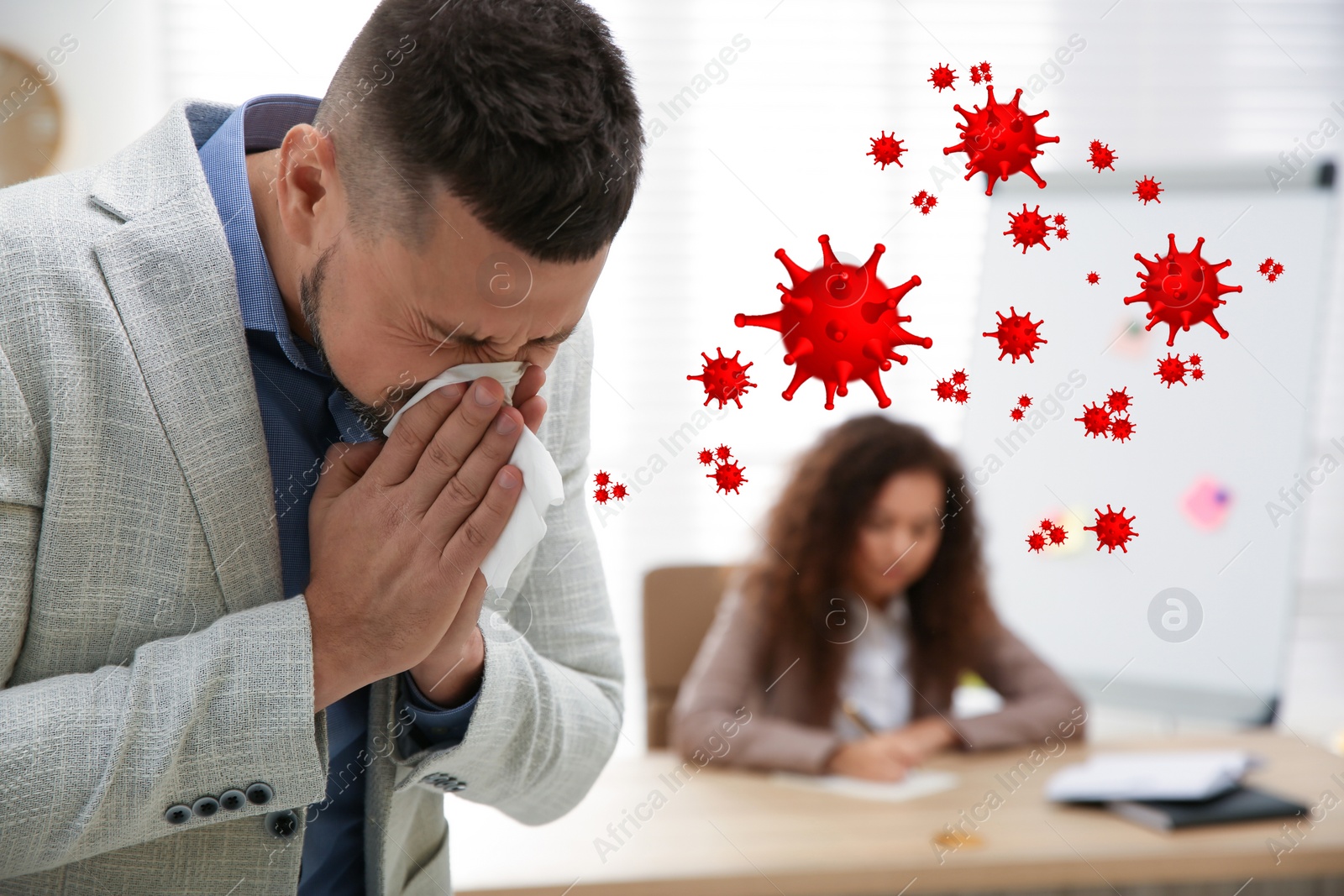 Image of Sick man sneezing in office. Dangerous virus
