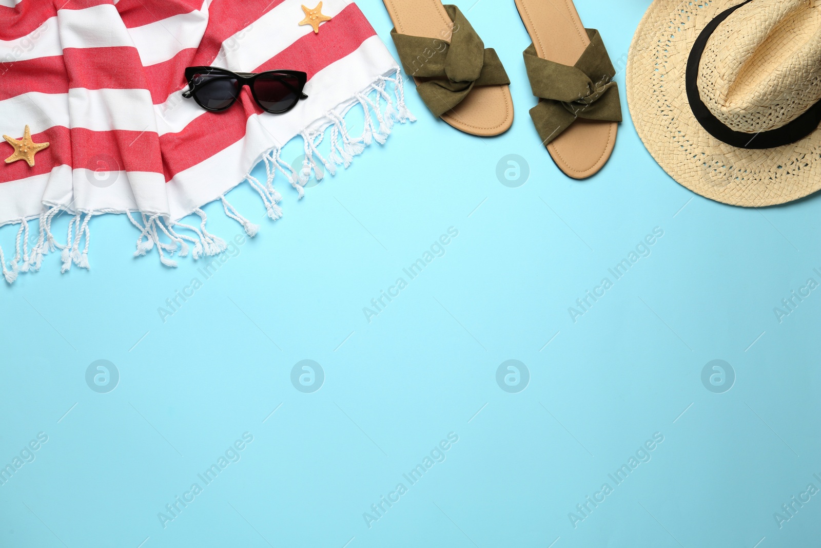 Photo of Flat lay composition with different beach objects on light blue background, space for text