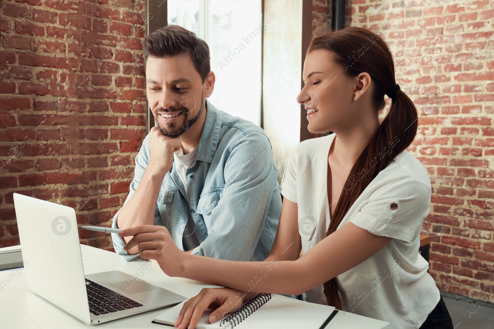 Photo of Team of employees working together in office