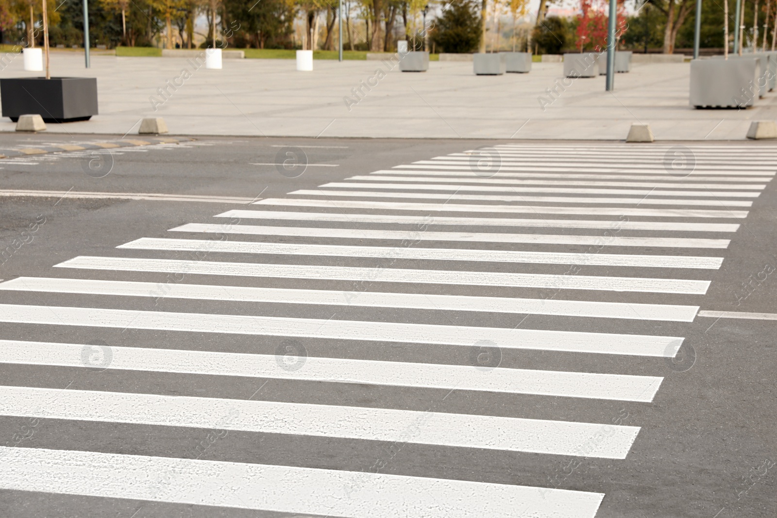 Photo of White pedestrian crossing on empty city street