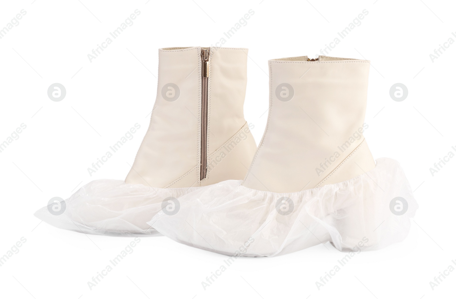 Photo of Women's boots in shoe covers isolated on white