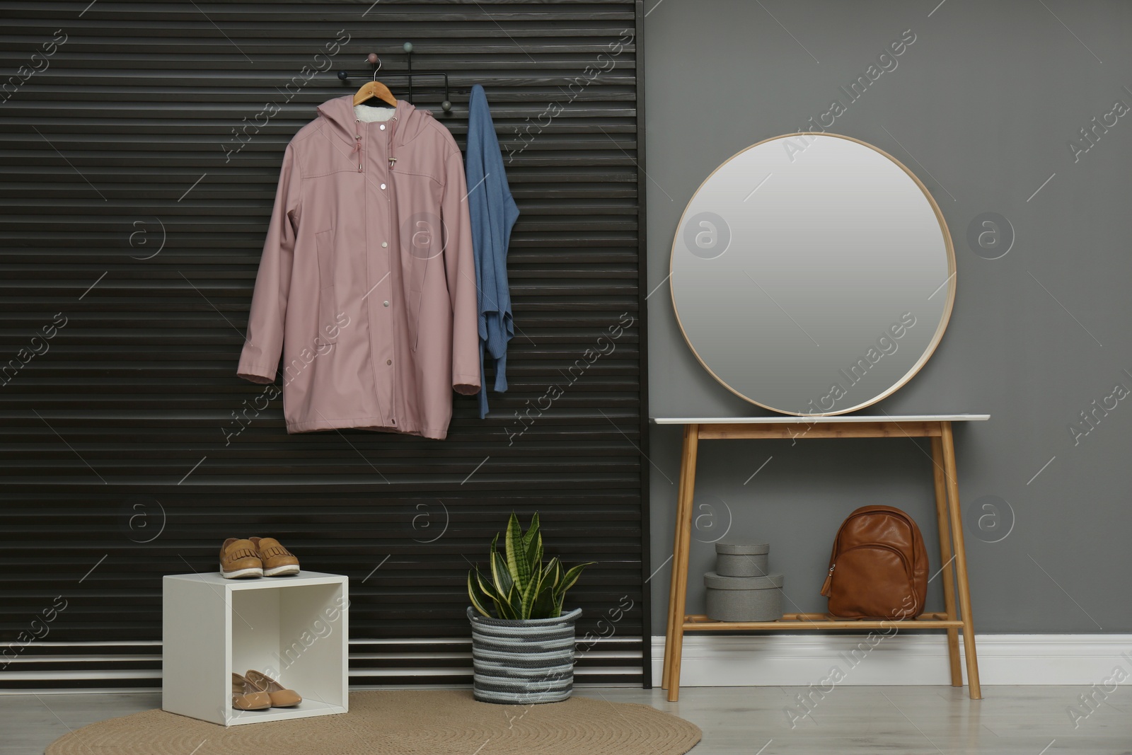 Photo of Hallway interior with stylish furniture, clothes and accessories