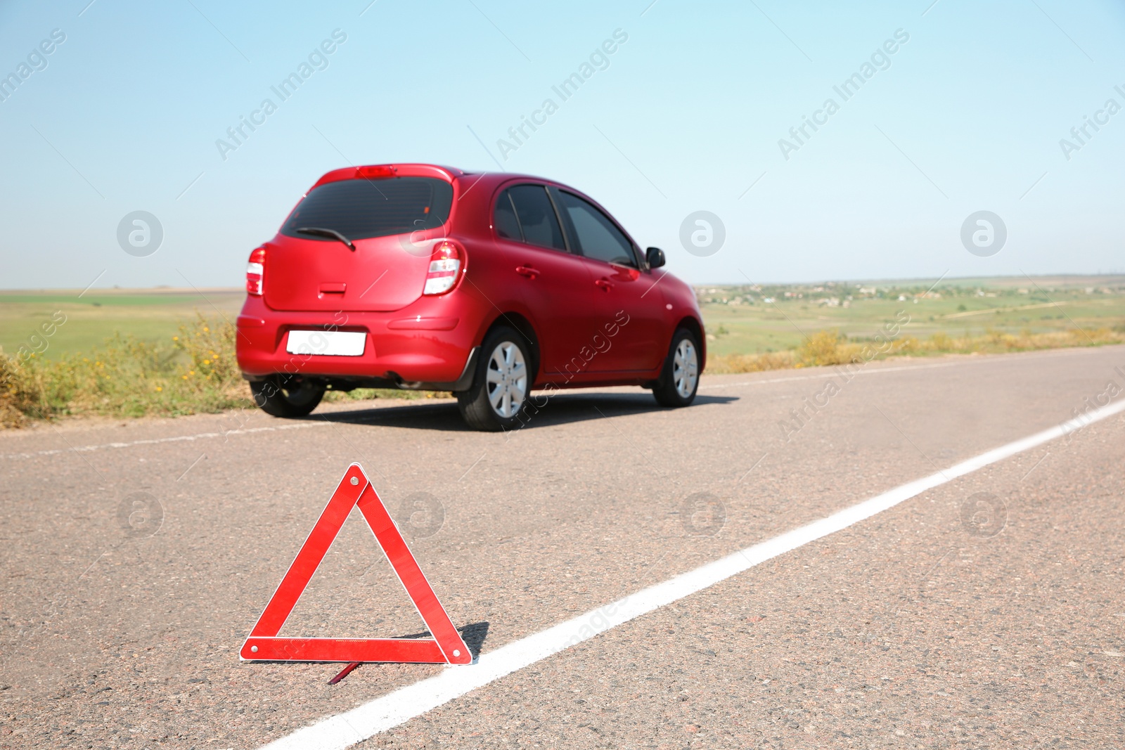 Photo of Emergency stop sign and broken car on background. Space for text