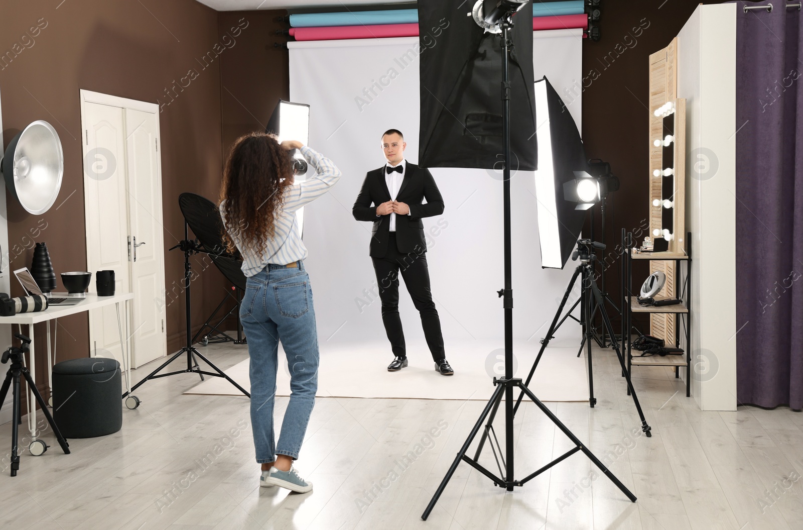 Photo of Handsome model posing for professional photographer in studio