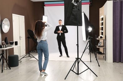 Handsome model posing for professional photographer in studio