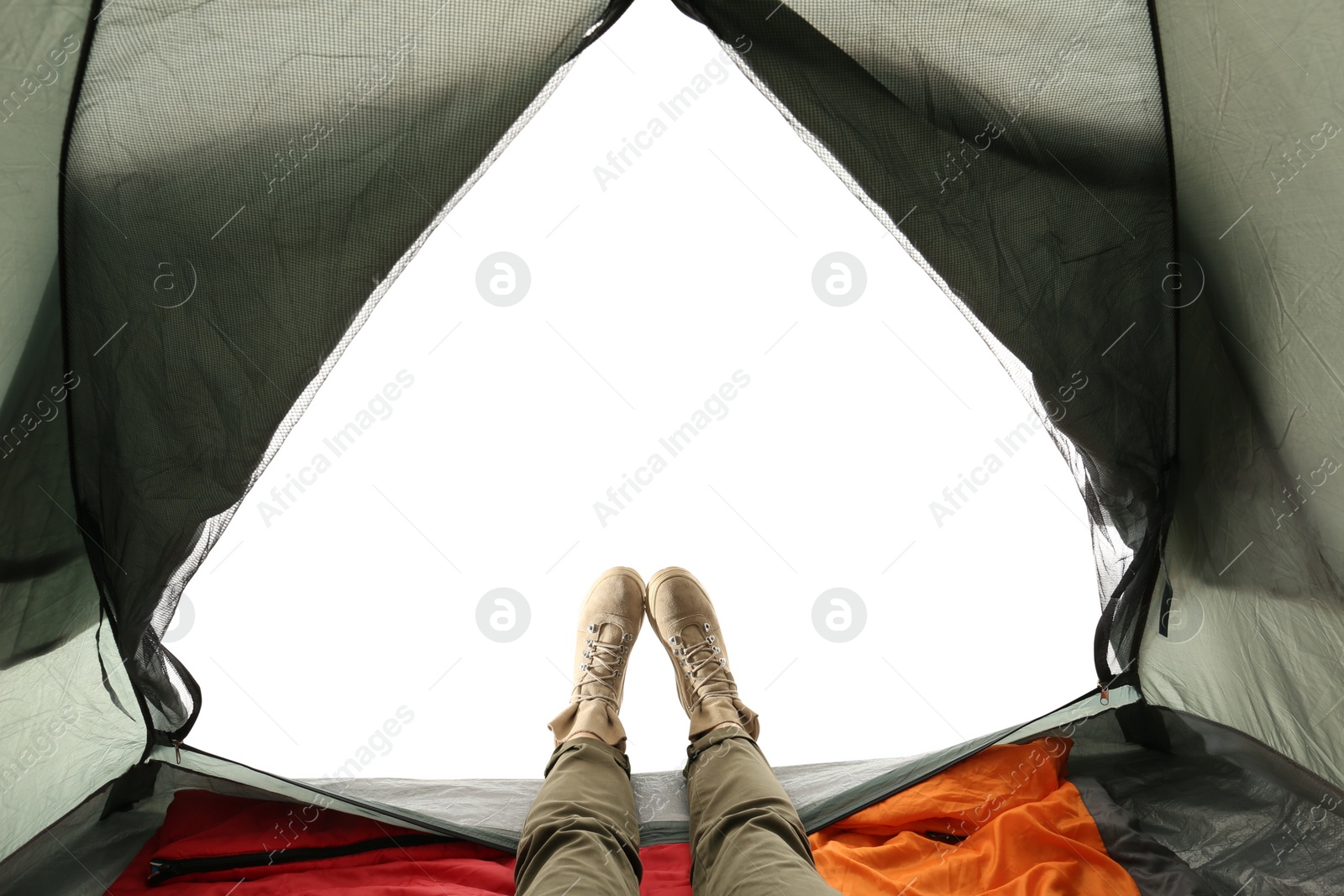 Photo of Closeup of female in camping tent on white background, view from inside