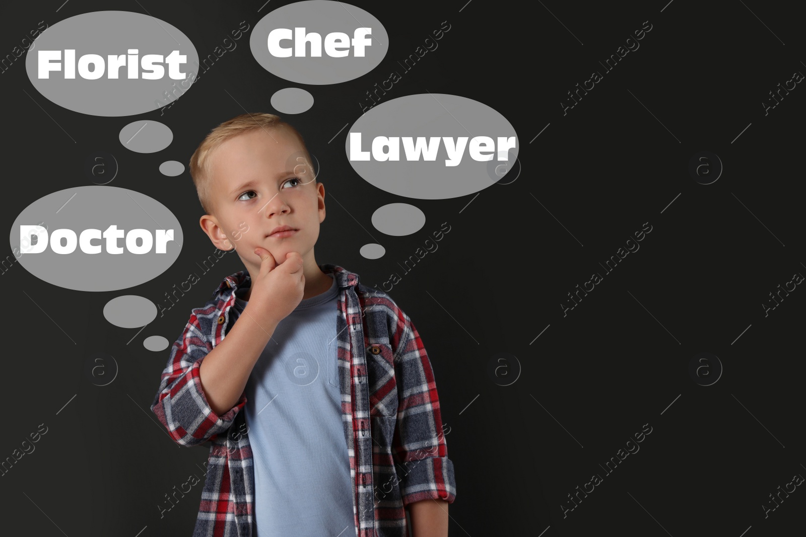 Image of Thoughtful little boy choosing profession on dark background