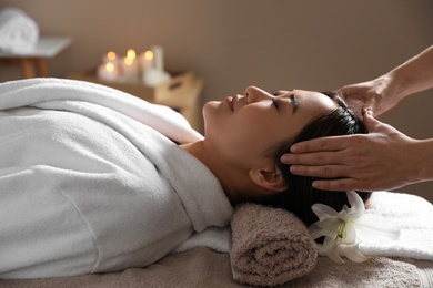 Photo of Beautiful Asian woman getting head massage in spa salon