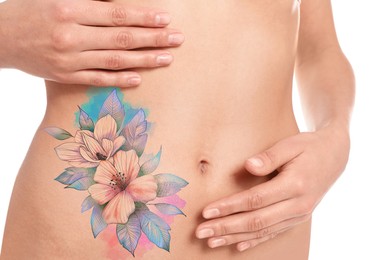 Young woman with beautiful floral tattoo on white background, closeup