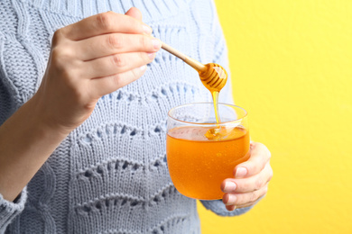 Photo of Woman with jar of fresh honey, closeup