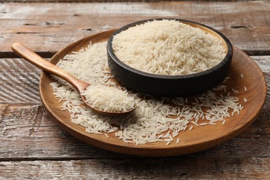 Photo of Uncooked raw basmati rice on wooden table