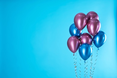 Photo of Bright balloons on color background. Space for text