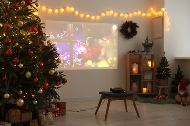 Video projector, Christmas tree, gifts and decorations in room