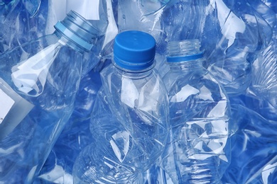 Photo of Pile of crumpled plastic bottles as background, closeup. Recycling problem