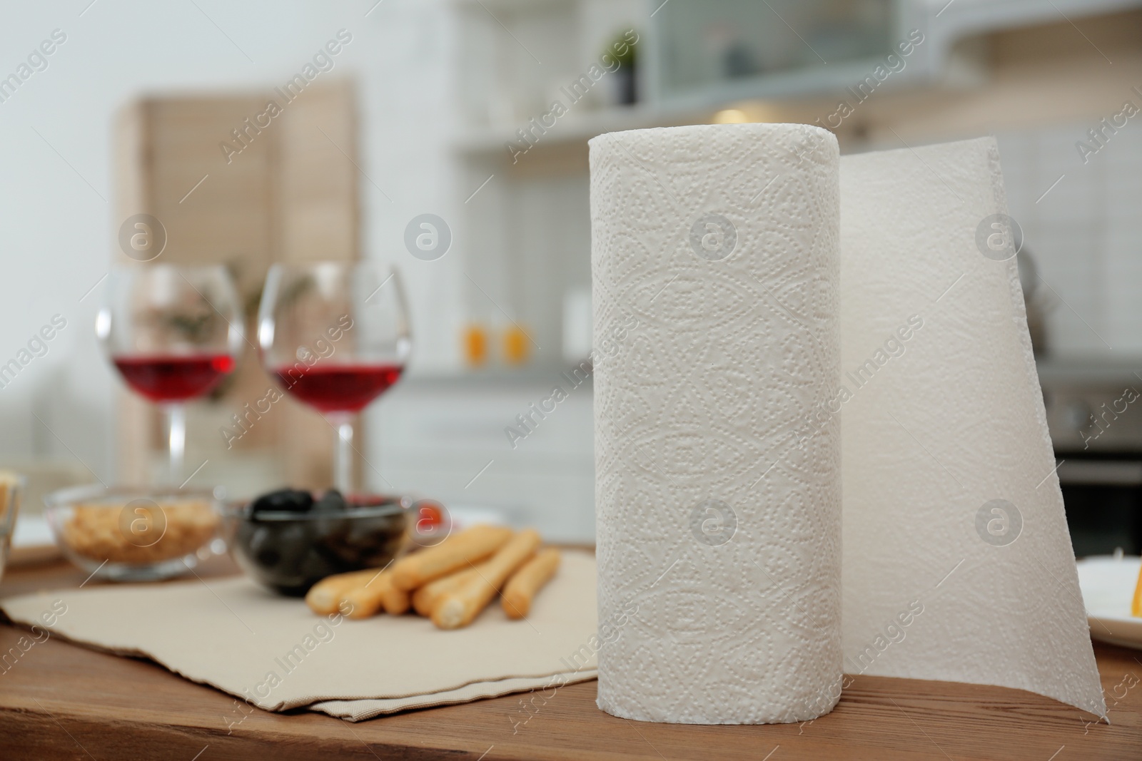 Photo of Roll of paper towels on table in kitchen, space for text