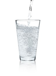 Photo of Pouring soda water into glass on white background