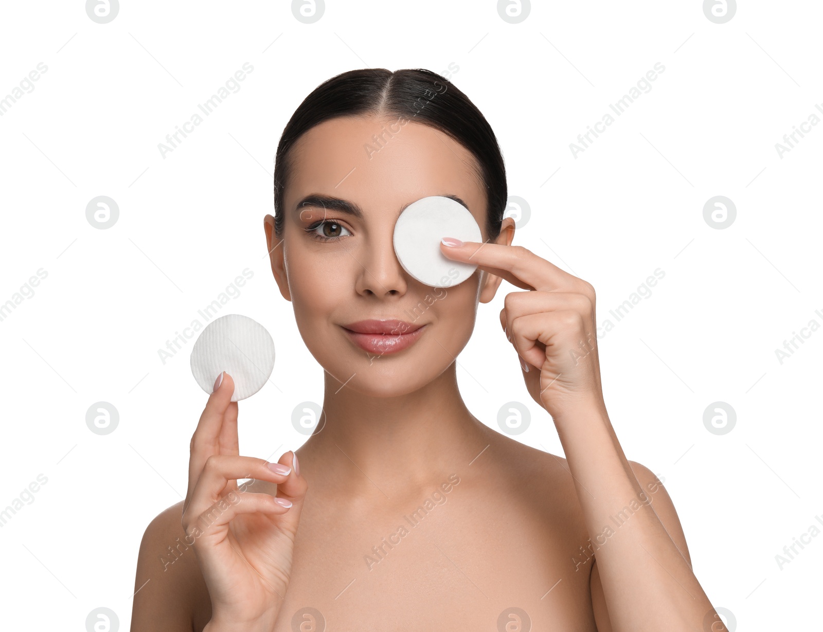 Photo of Beautiful woman removing makeup with cotton pads on white background