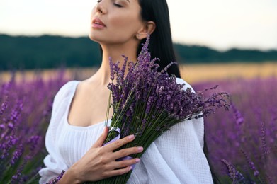 Photo of Woman with bouquet in lavender field, closeup