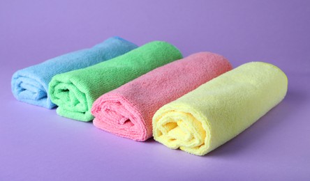 Many colorful microfiber cloths on light background