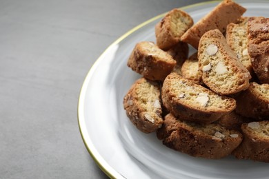 Photo of Traditional Italian almond biscuits (Cantucci) on grey table, closeup