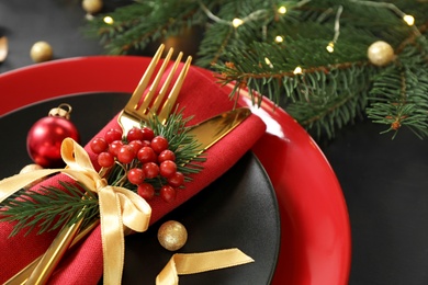 Photo of Beautiful Christmas table setting on black background, closeup