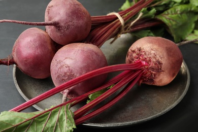 Photo of Raw ripe beets on metal platter, closeup