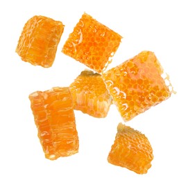 Image of Pieces of honeycomb falling on white background