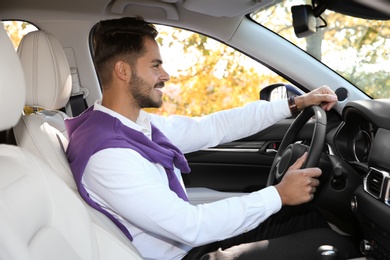 Young man in driver's seat of modern car