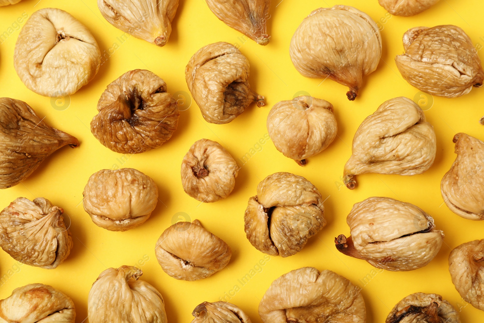 Photo of Flat lay composition with dried figs on  color background. Healthy fruit