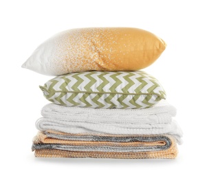 Photo of Stylish soft pillows and folded plaids on white background