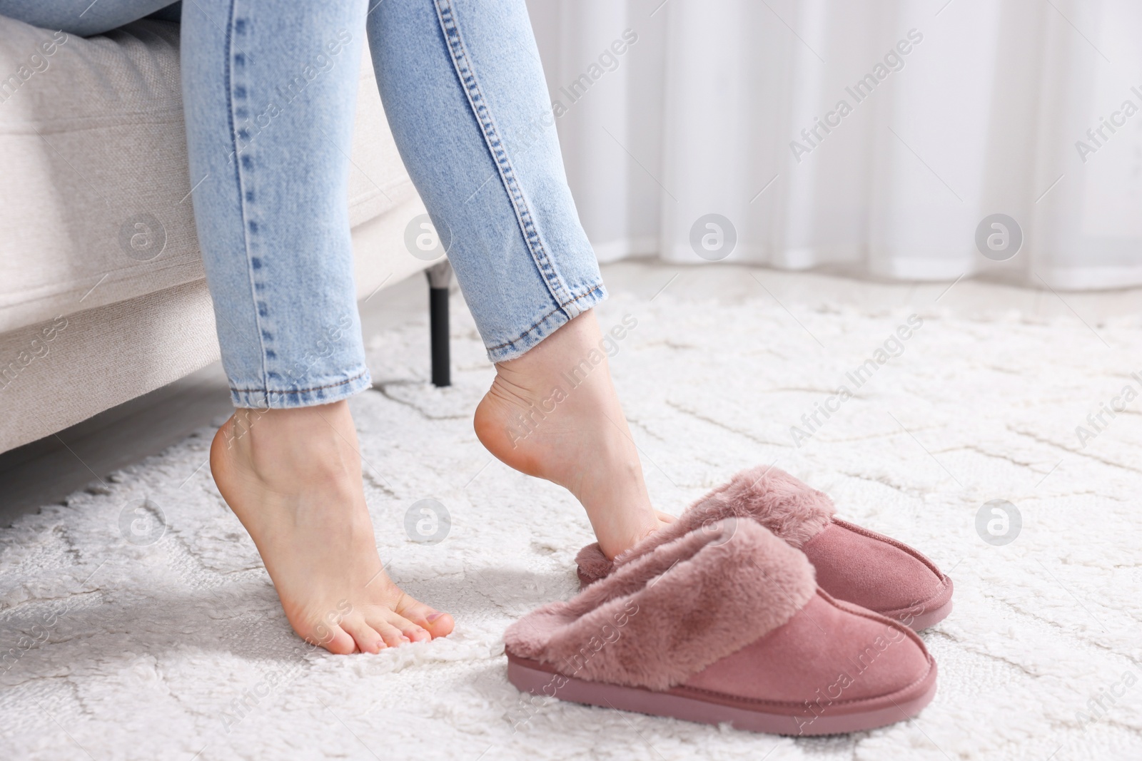 Photo of Woman wearing soft slippers at home, closeup