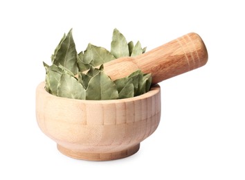 Photo of Wooden mortar with aromatic bay leaves and pestle isolated on white