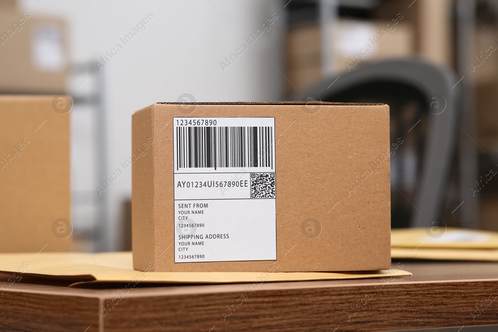 Photo of Parcel on wooden table in office. Online store