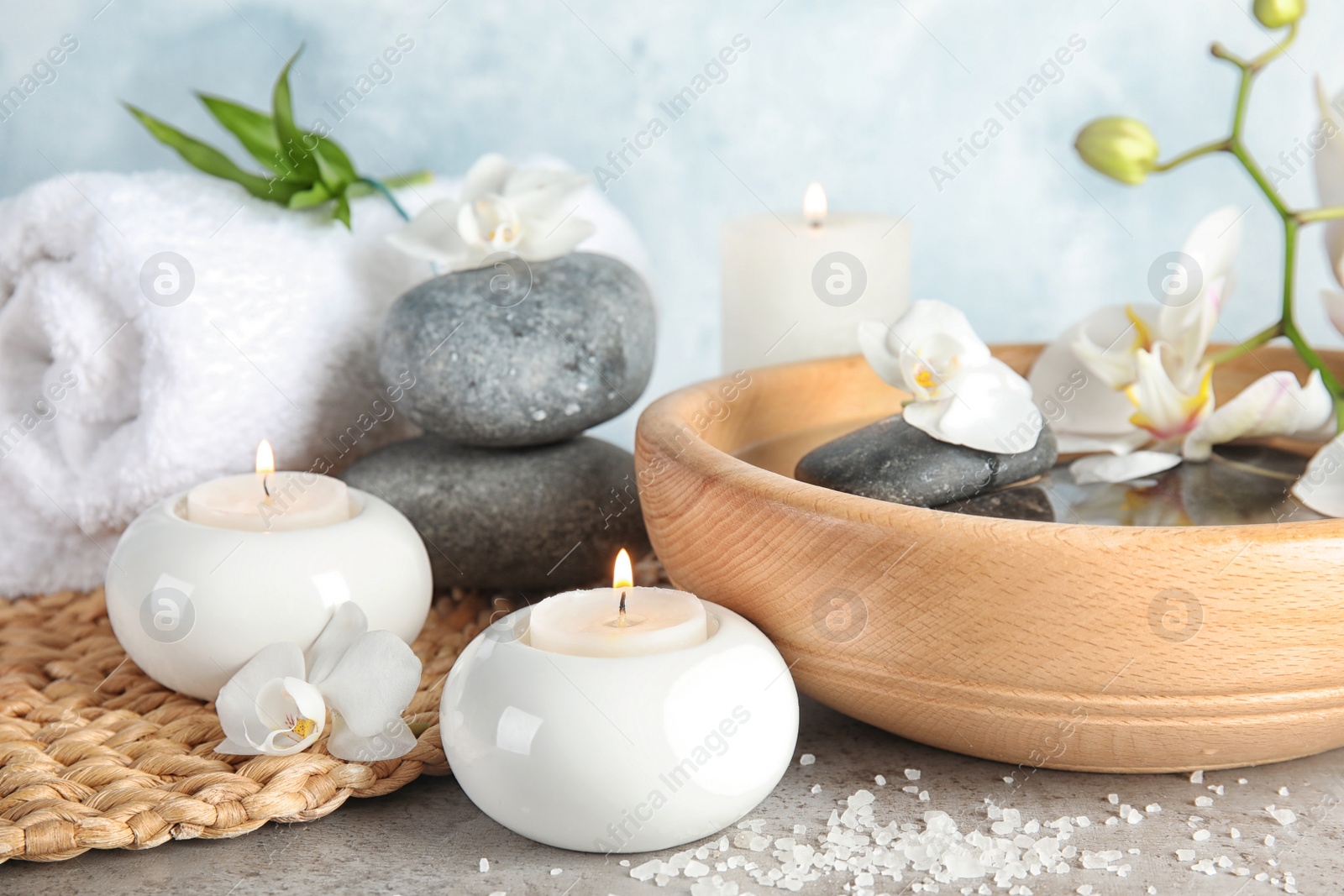 Photo of Composition with spa stones and candles on gray table