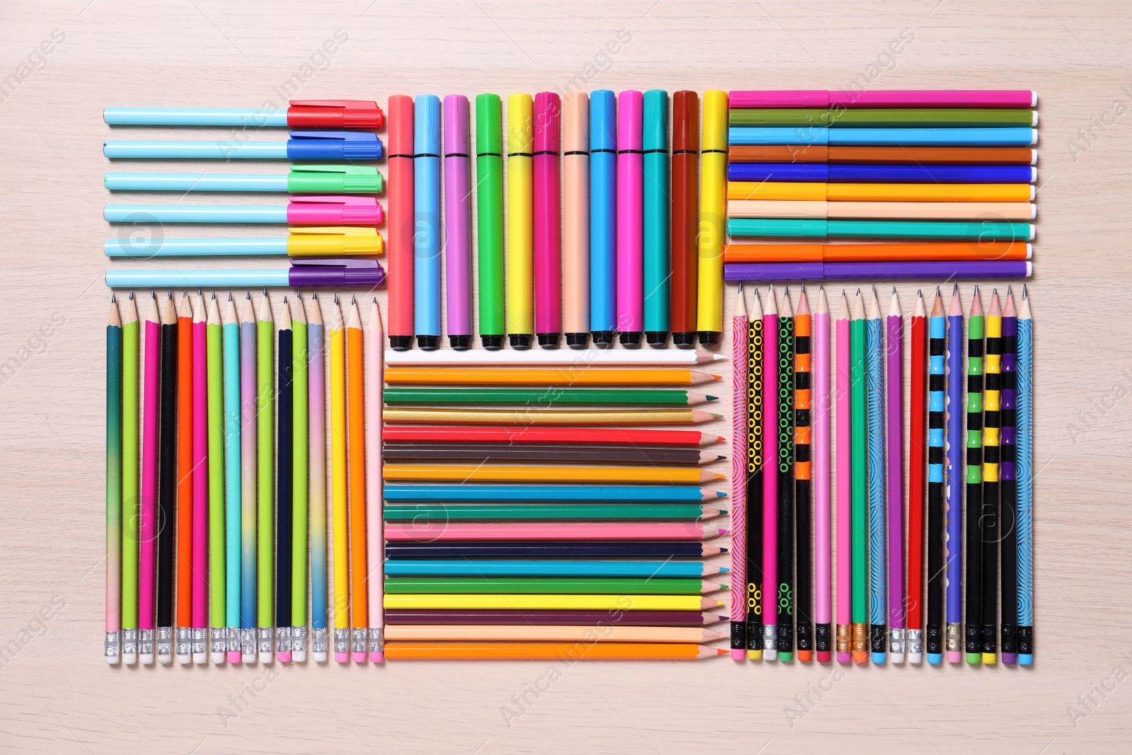 Photo of Different school stationery on wooden table, flat lay