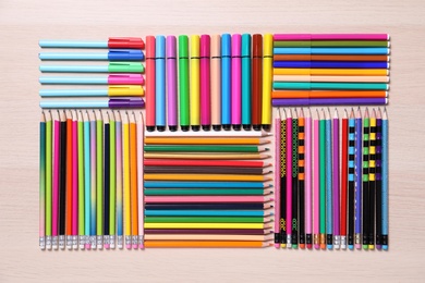 Different school stationery on wooden table, flat lay