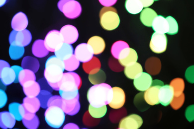 Photo of Blurred view of colorful lights on black background. Bokeh effect
