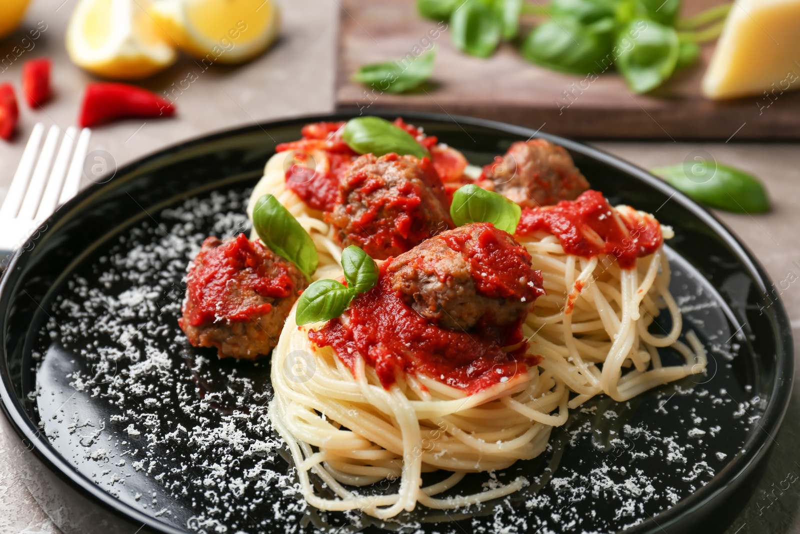 Photo of Delicious pasta with meatballs and tomato sauce on plate, closeup